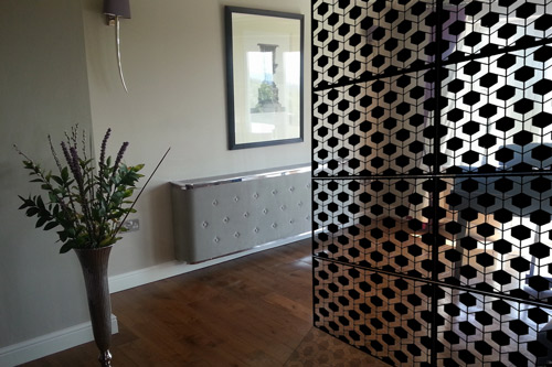 black geodots laser cut metal room partitions in piano room with shadow